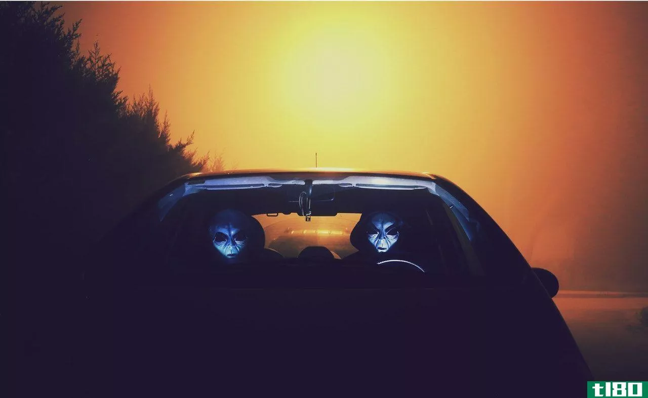 two aliens inside a car