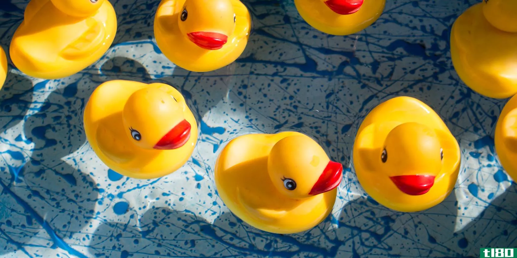 Seven yellow rubber ducks sitting in water
