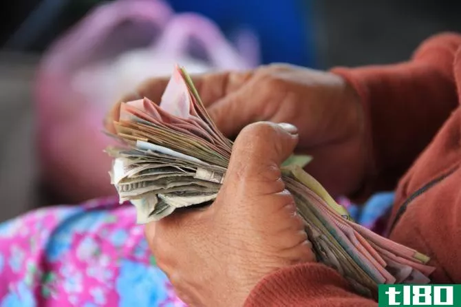 Hands holding stack of money