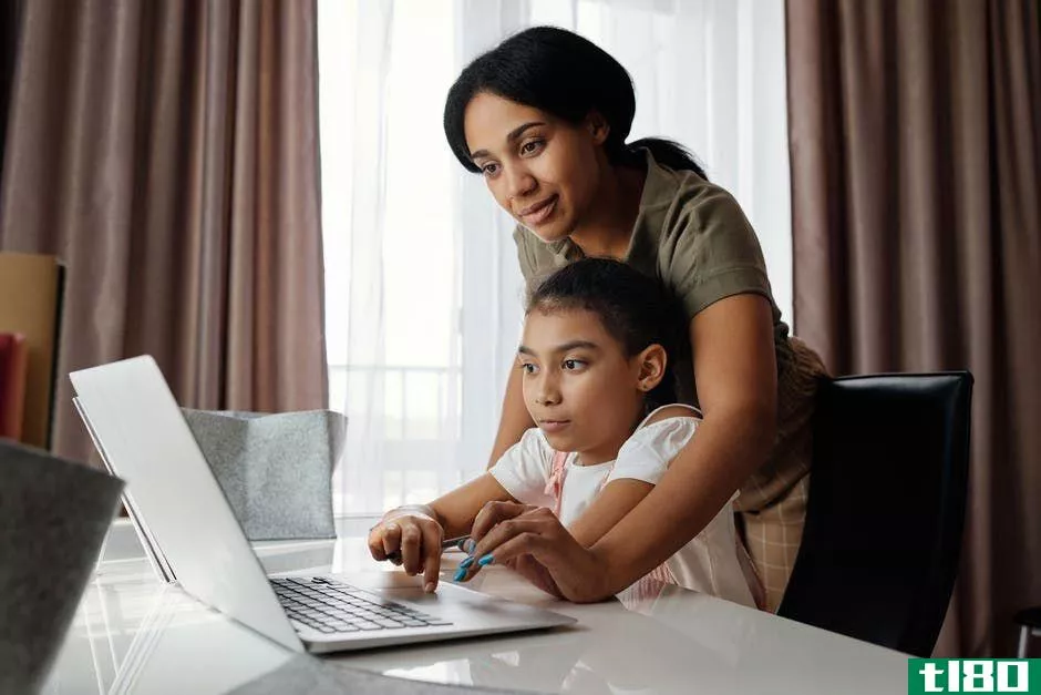 child and mother with laptop