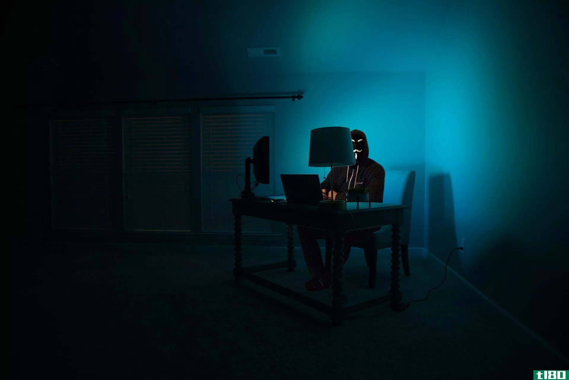 Stereotypical hacker in a dark room