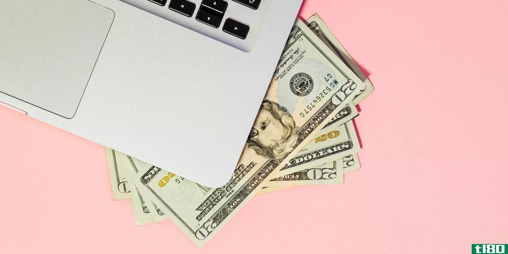 mac laptop and money in notes