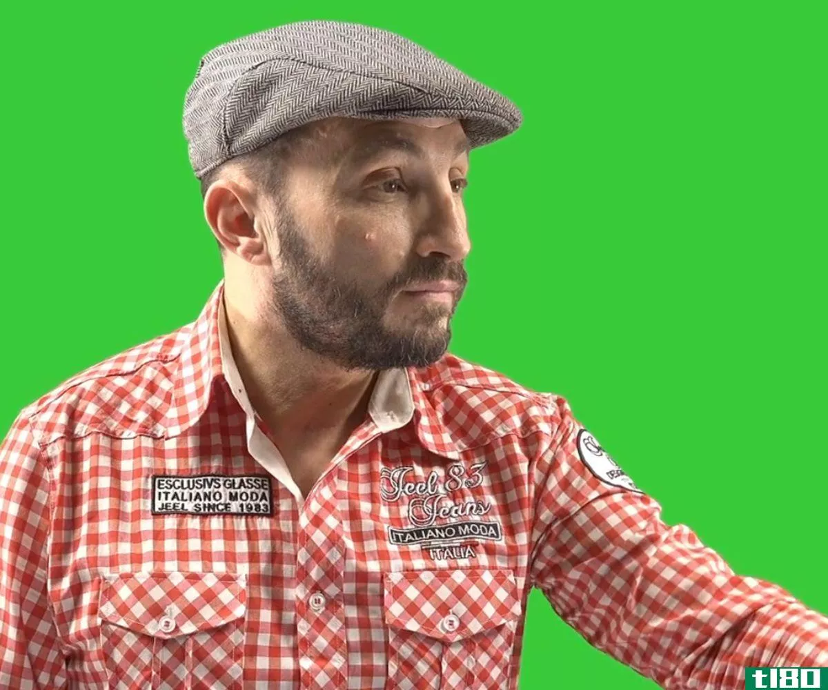 Male subject behind green screen 