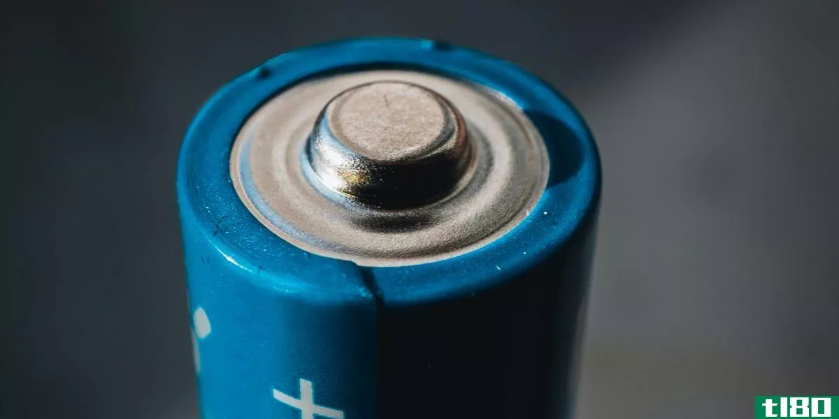 Blue battery on grey background 