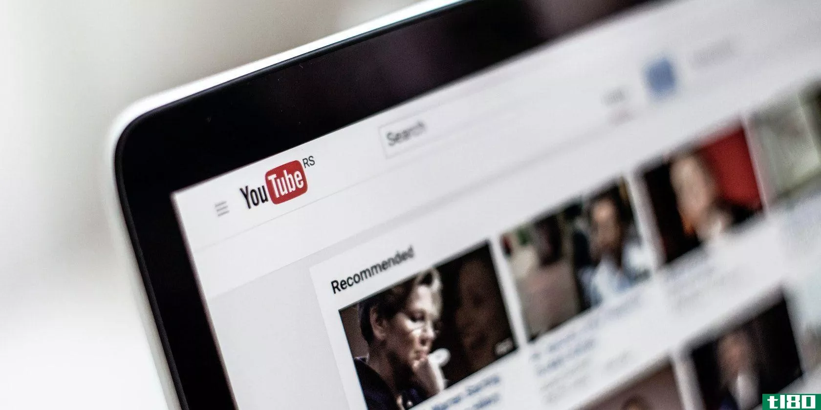 A photograph of a laptop screen displaying YouTube