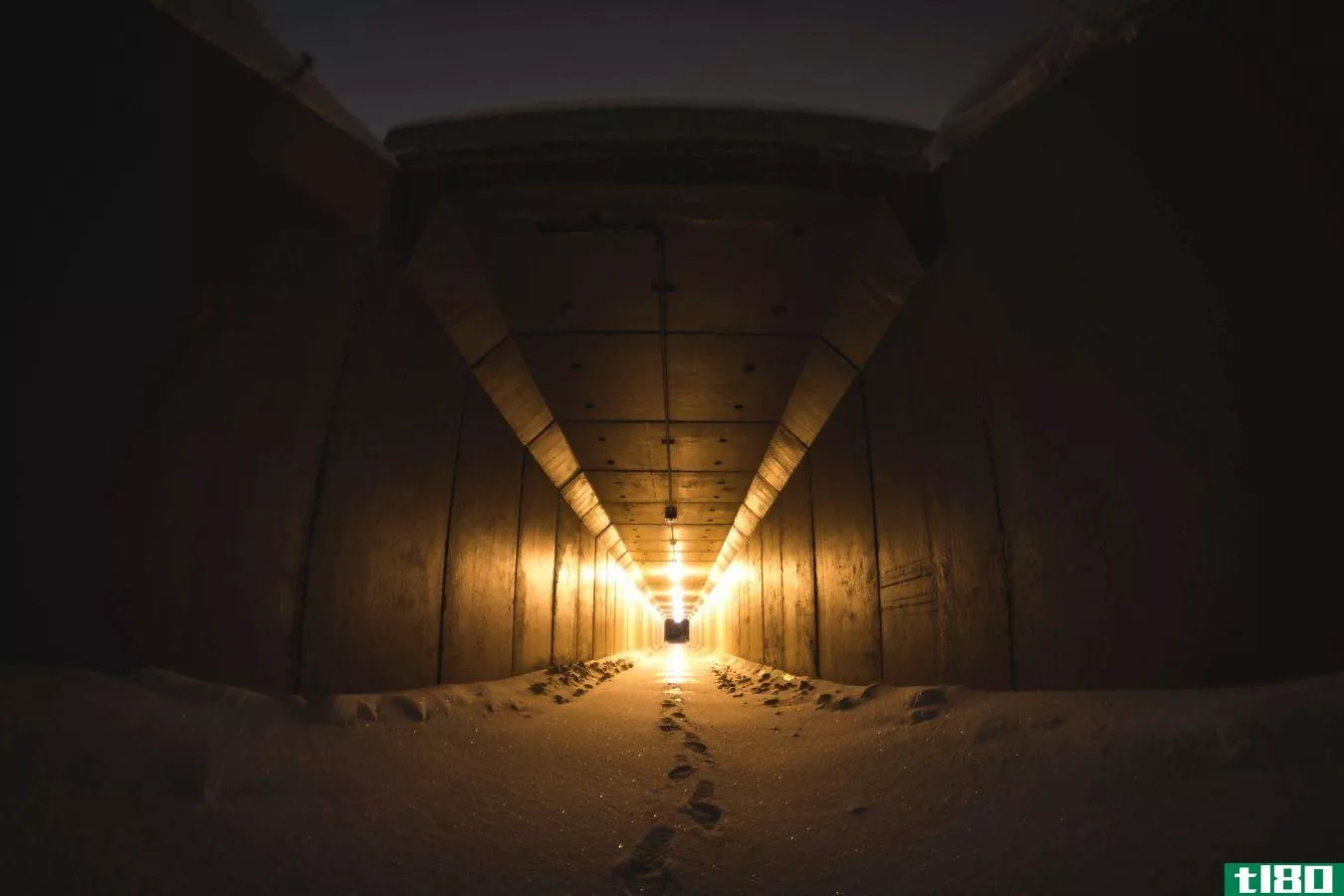 footprints on a dark snow covered path