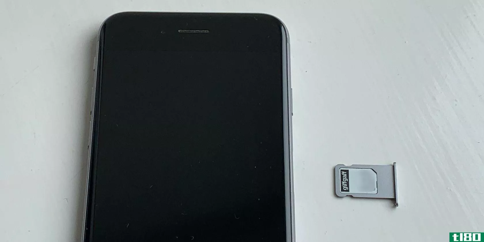 SIM card in tray next to iPhone