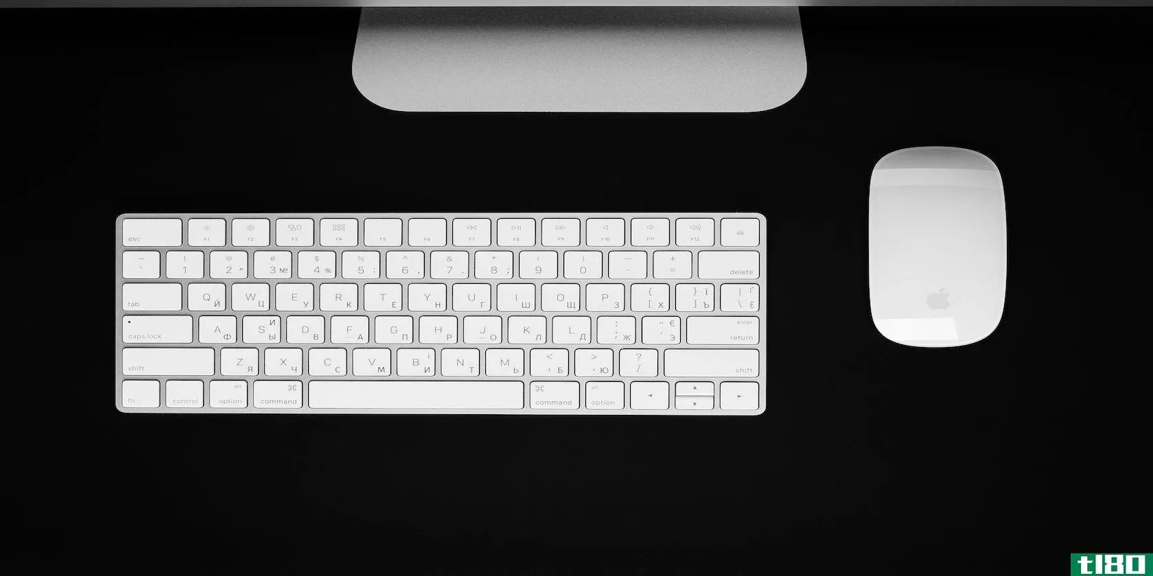 Apple Magic Keyboard on a desk next to a mouse