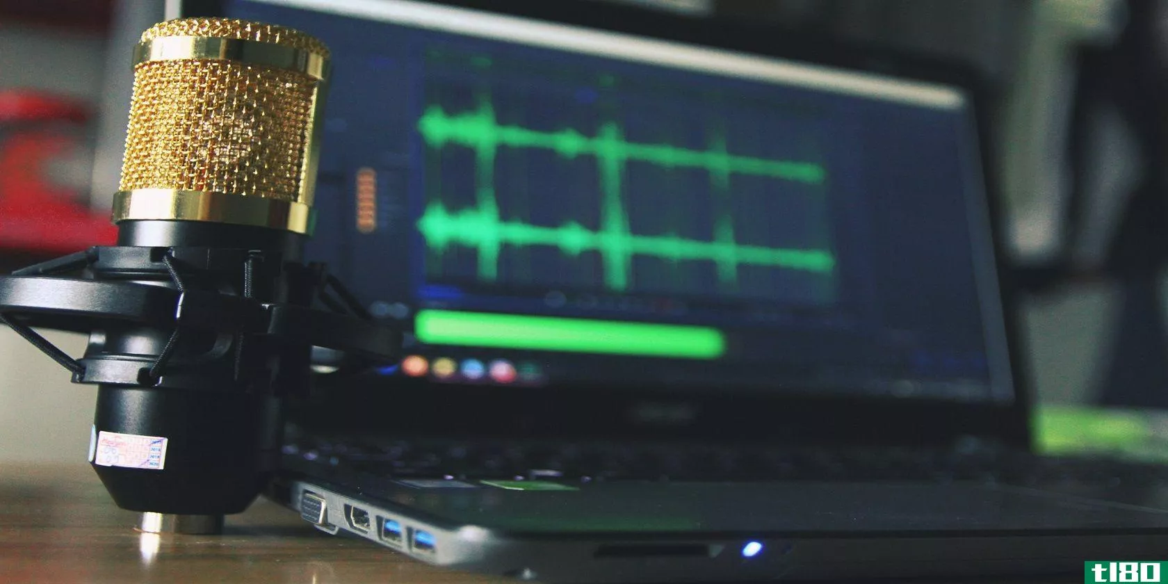 Image of microphone and audio editing software on a laptop screen