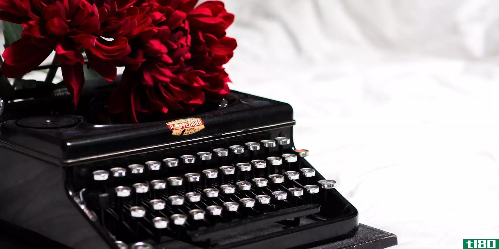 black typewriter and red flowers