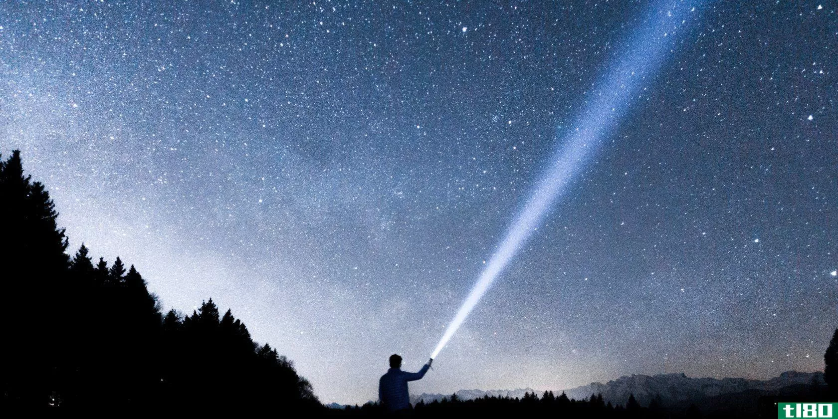 someone shining a flashlight into a starry sky
