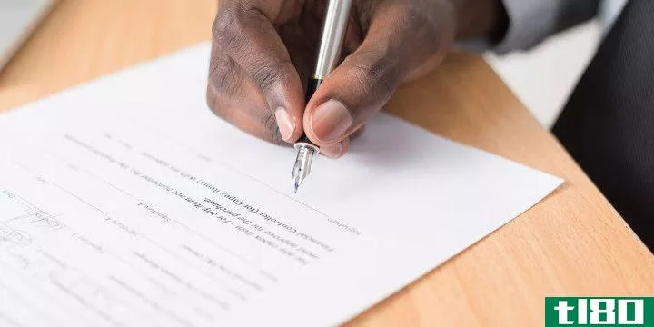 a hand signing a contract