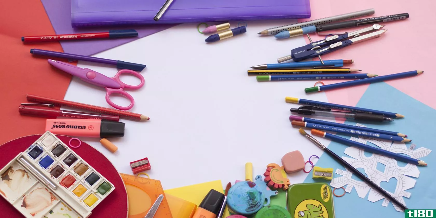 A collection of different colored art supplies arranged in a circle