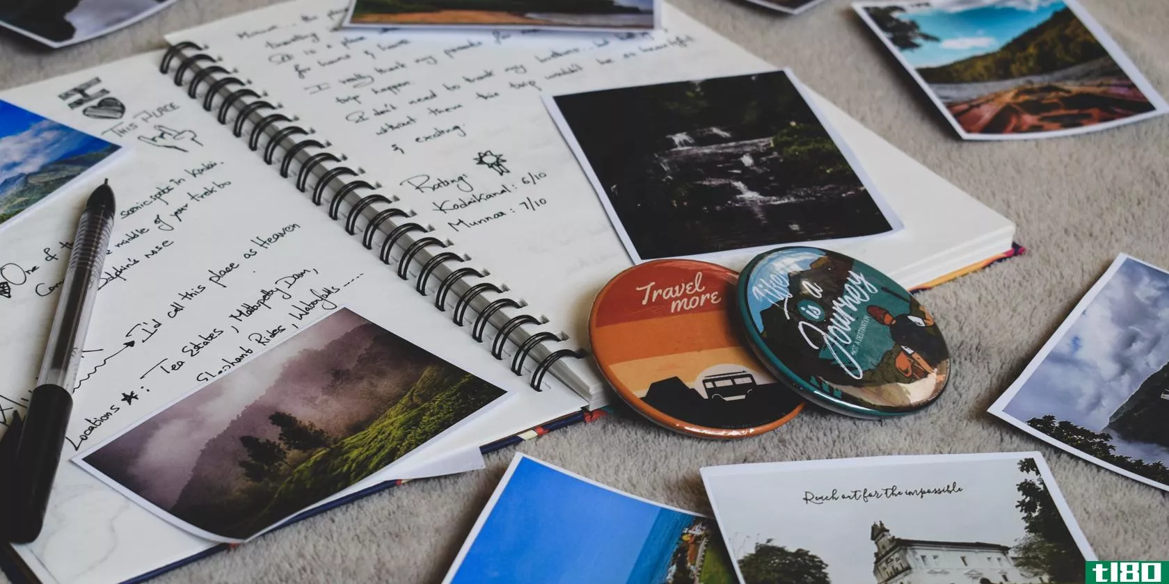 A ringed notebook surrounded by scattered photographs