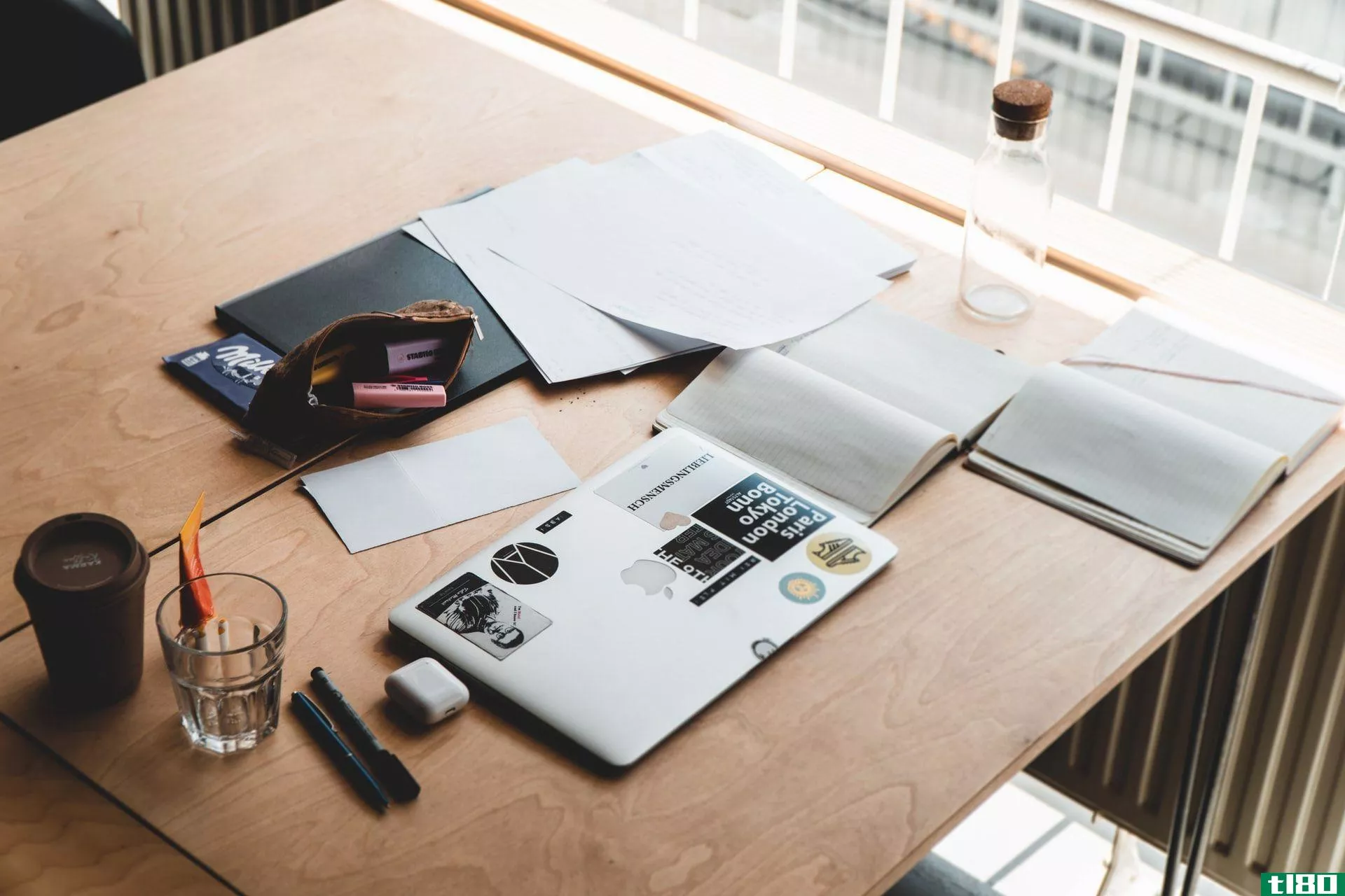 Organized desk with notebooks and a laptop