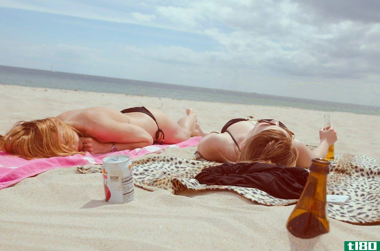 women sunbathing on a beach