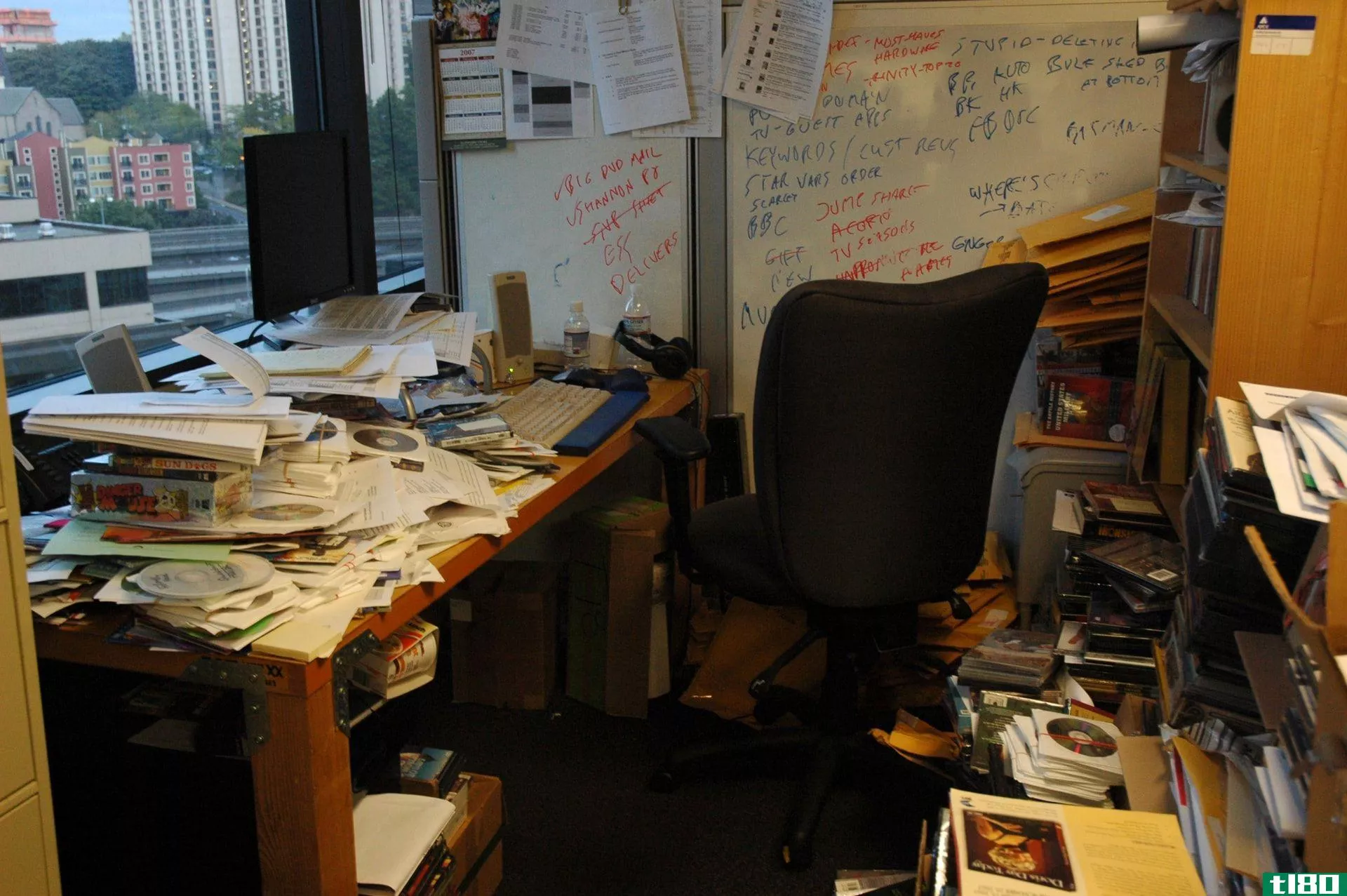 A messy office with lots of paper and trash