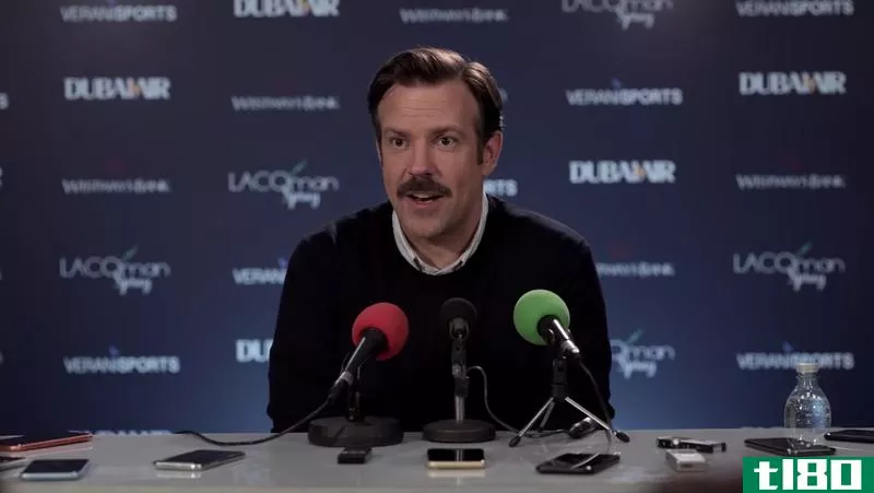 Screenshot from Ted Lasso: Ted speaking at a press conference