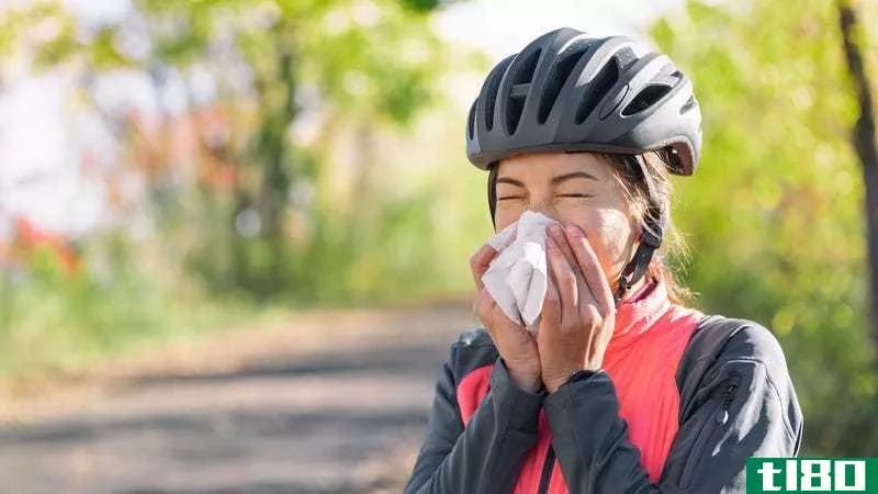 Cyclist blowing her nose
