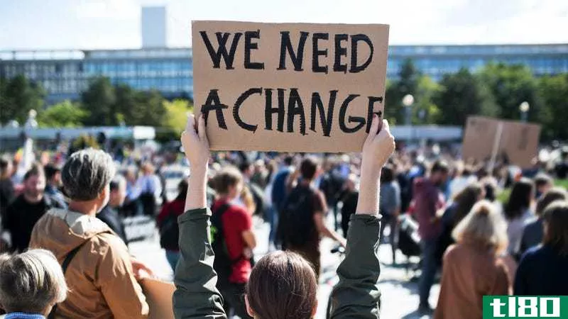 protest sign: "we need a change"