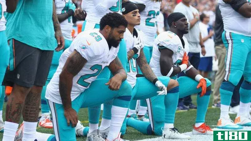 Arian Foster #29, Kenny Stills #10 and Michael Thomas #31 of the Miami Dolphins making a political statement, just like everyone who remained standing or complained about any of the above was making a political statement. Photo by Maddie Meyer/Getty Images.