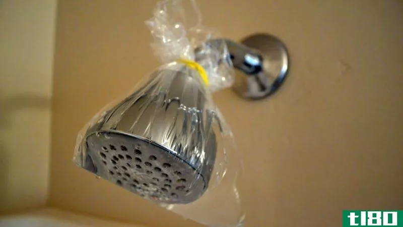 Illustration for article titled Tie a Bag of Vinegar Around Your Shower Head to Clean It with No Effort
