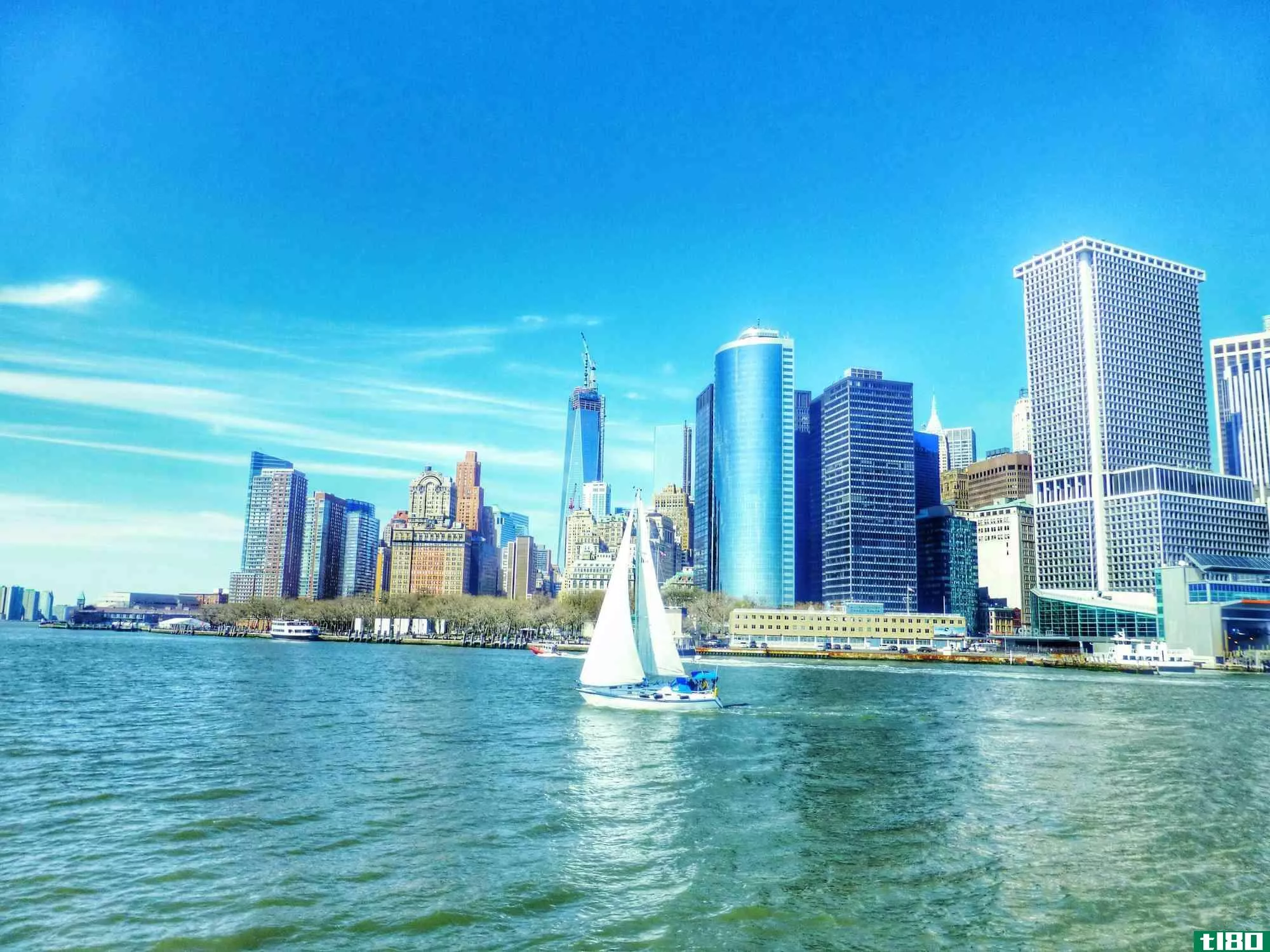 Sailboat on East River by Manhattan skyline, New York City.